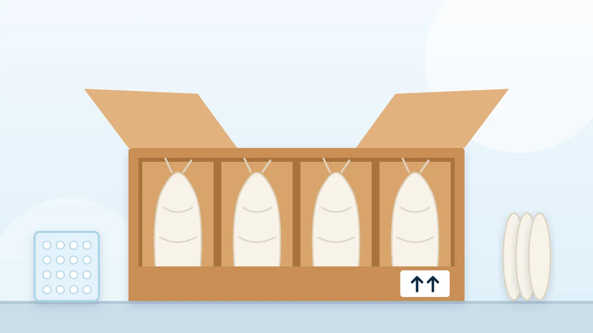 Illustration of fragile glassware wrapped in packing paper inside a divided moving box